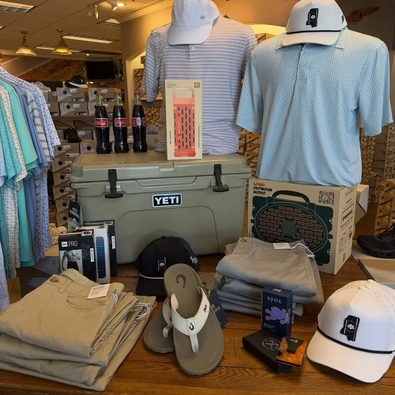 Store display with polos, caps, YETI cooler and sandals